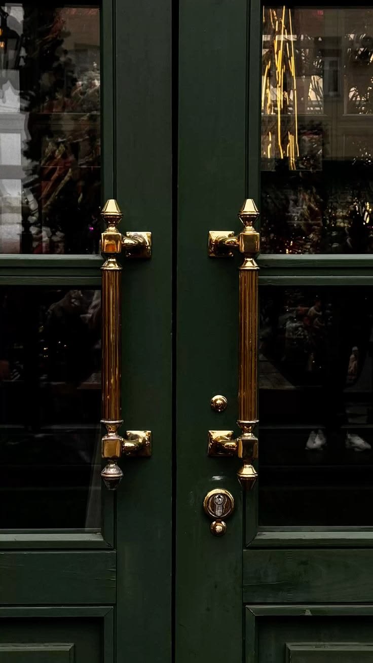 Deep green double doors with brass hardware